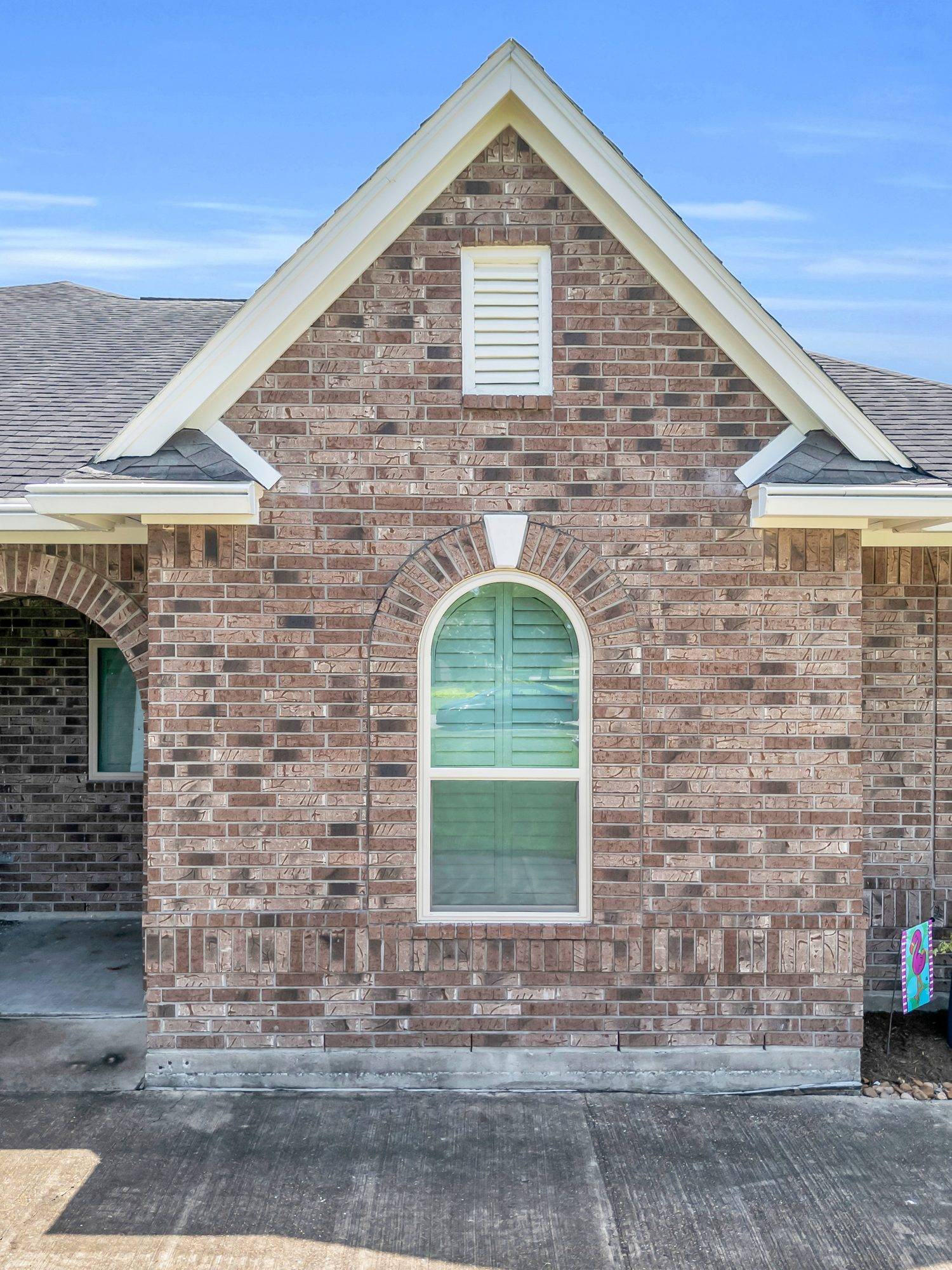 After — Arched window replacement — custom-fit units that keep the home's character.