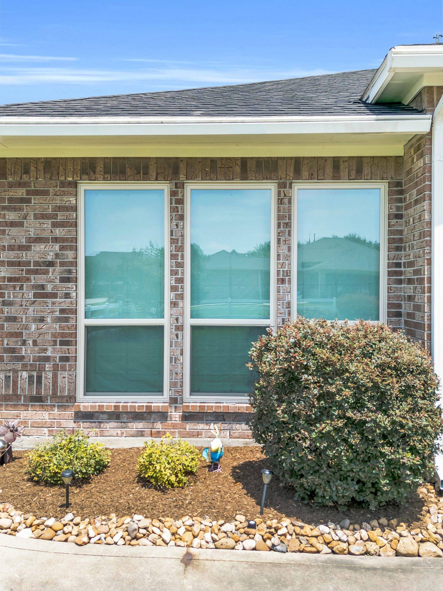 After — Full window replacement — Ravensway home, brick exterior refreshed with new energy-efficient units.